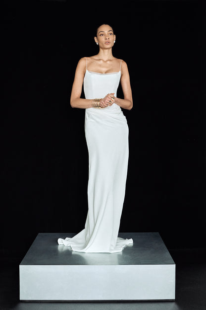 Front view of a woman in a corseted bridal gown with organza detailing at the neckline and slim straps