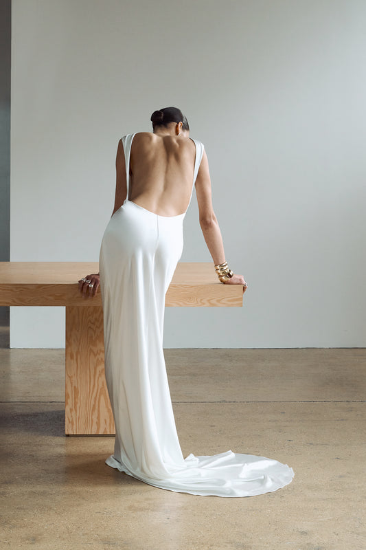 Back view showing an elegant, backless silk wedding gown