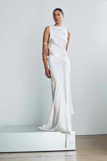 Front view of an elegant silk wedding gown, featuring a high neckline and sash ties styled at the hip
