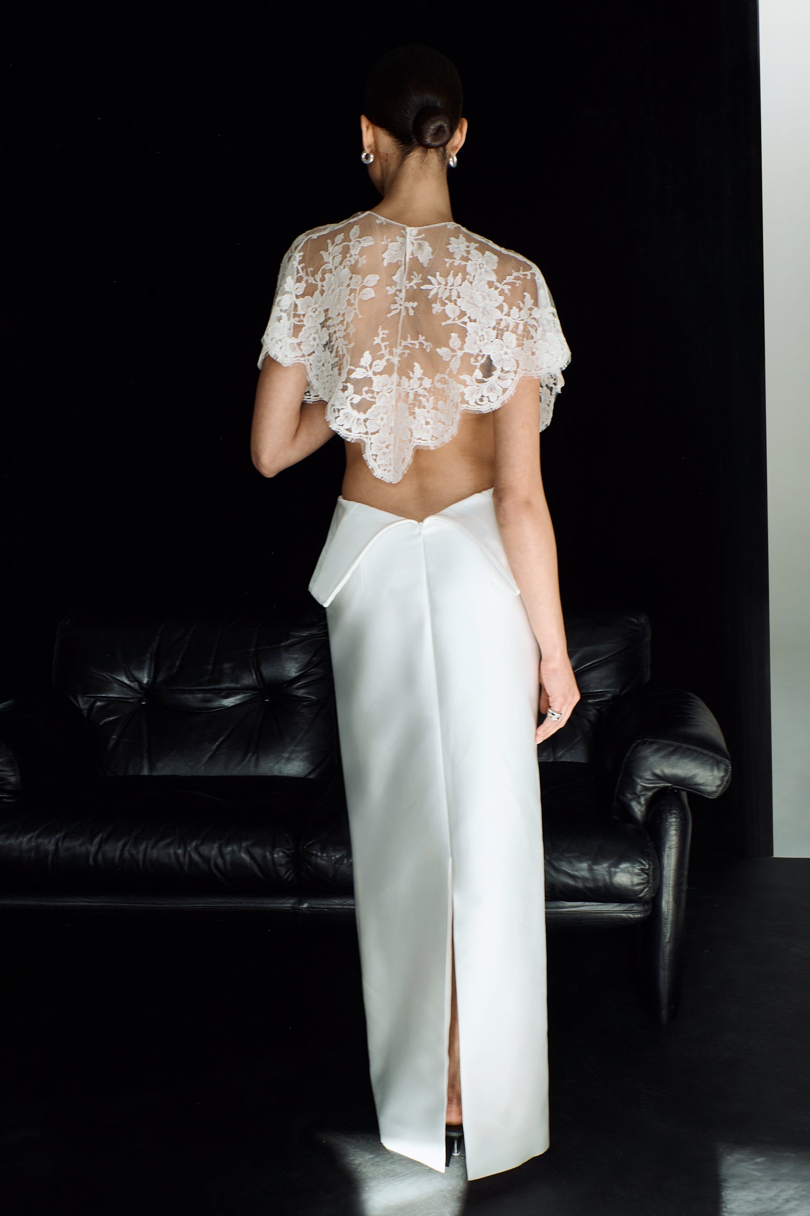 Full length shot showing the back view of a delicate lace mantle with a scallop trim