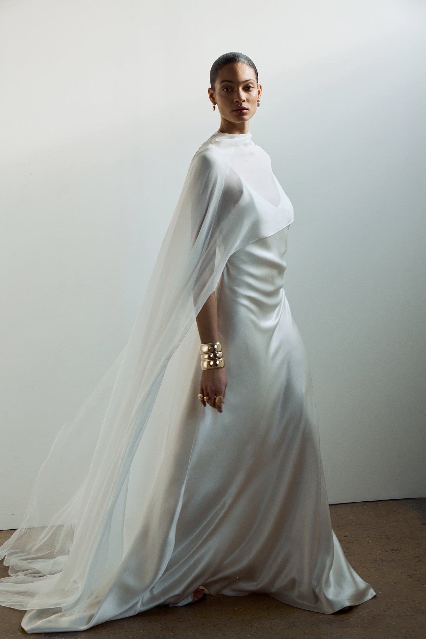 Flowing silk chiffon cape, worn over a minimalist slip dress