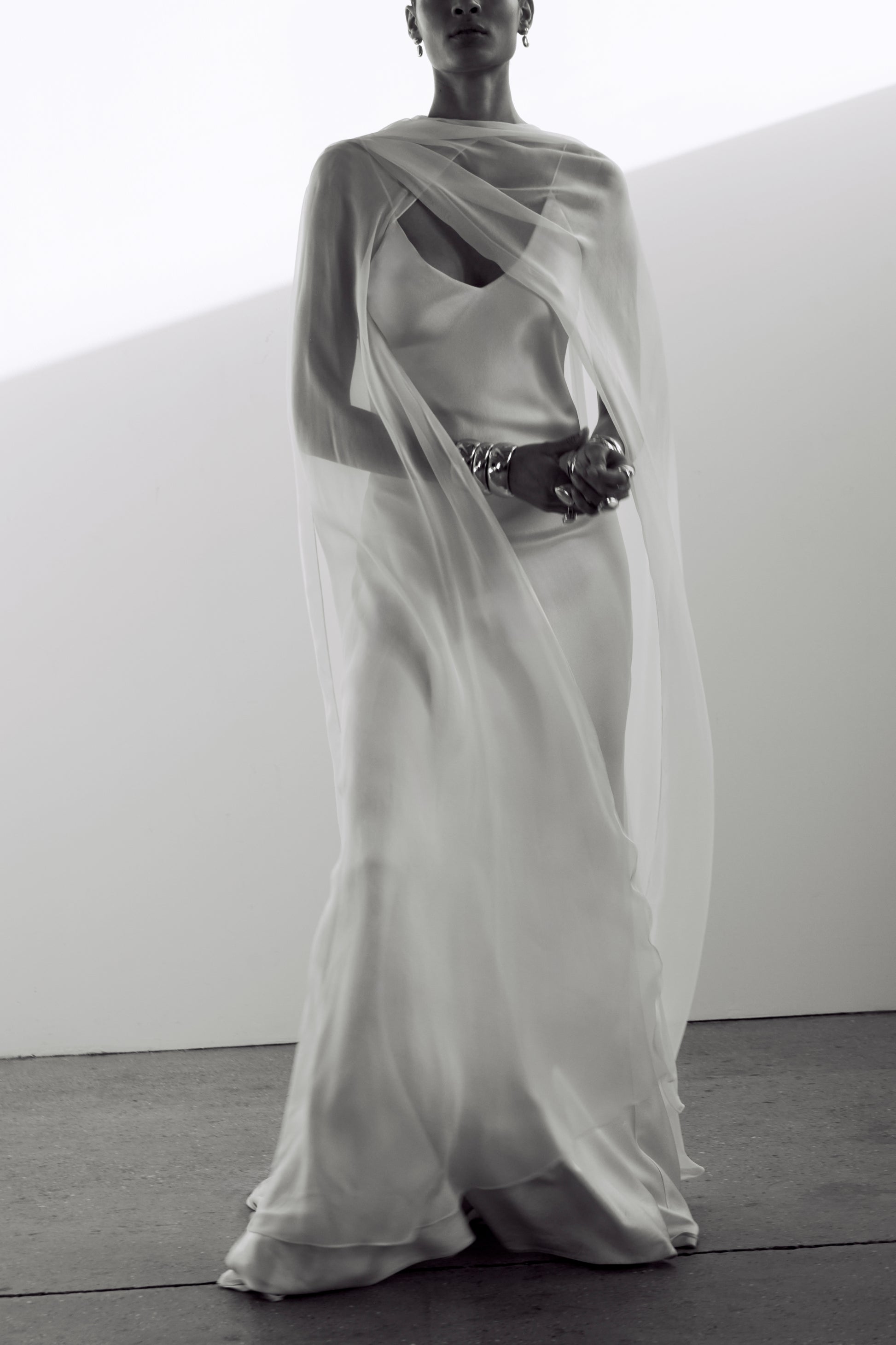 Elegant chiffon scarf cape, styled with an asymmetric neckline over a silk slip dress